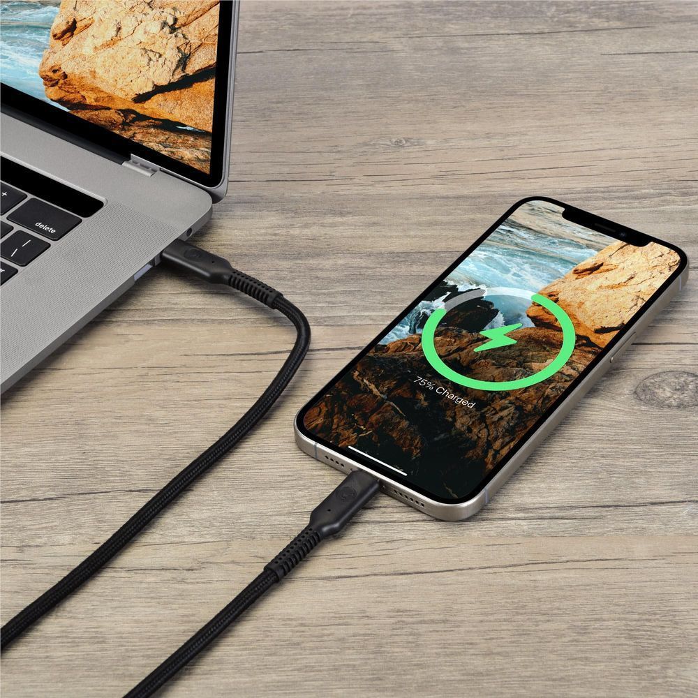 Black USB-C to USB-C cable connecting a smartphone to a laptop on a desk