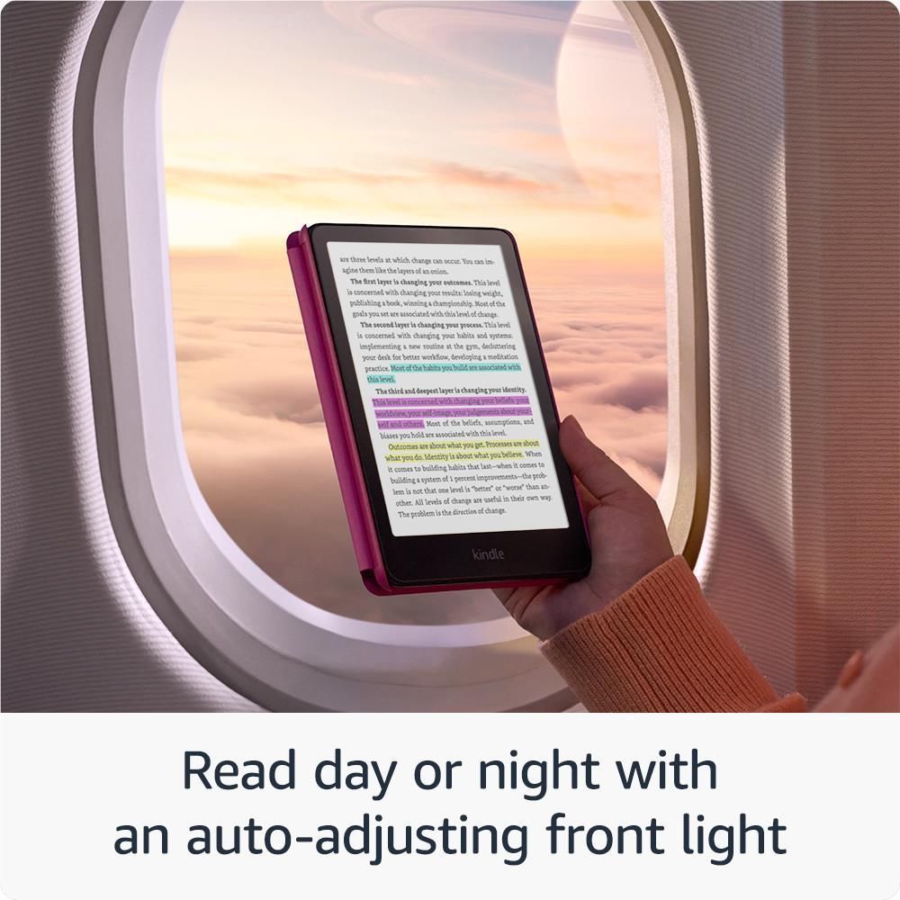 Red Kindle e-reader with text on color display, held near an arched opening