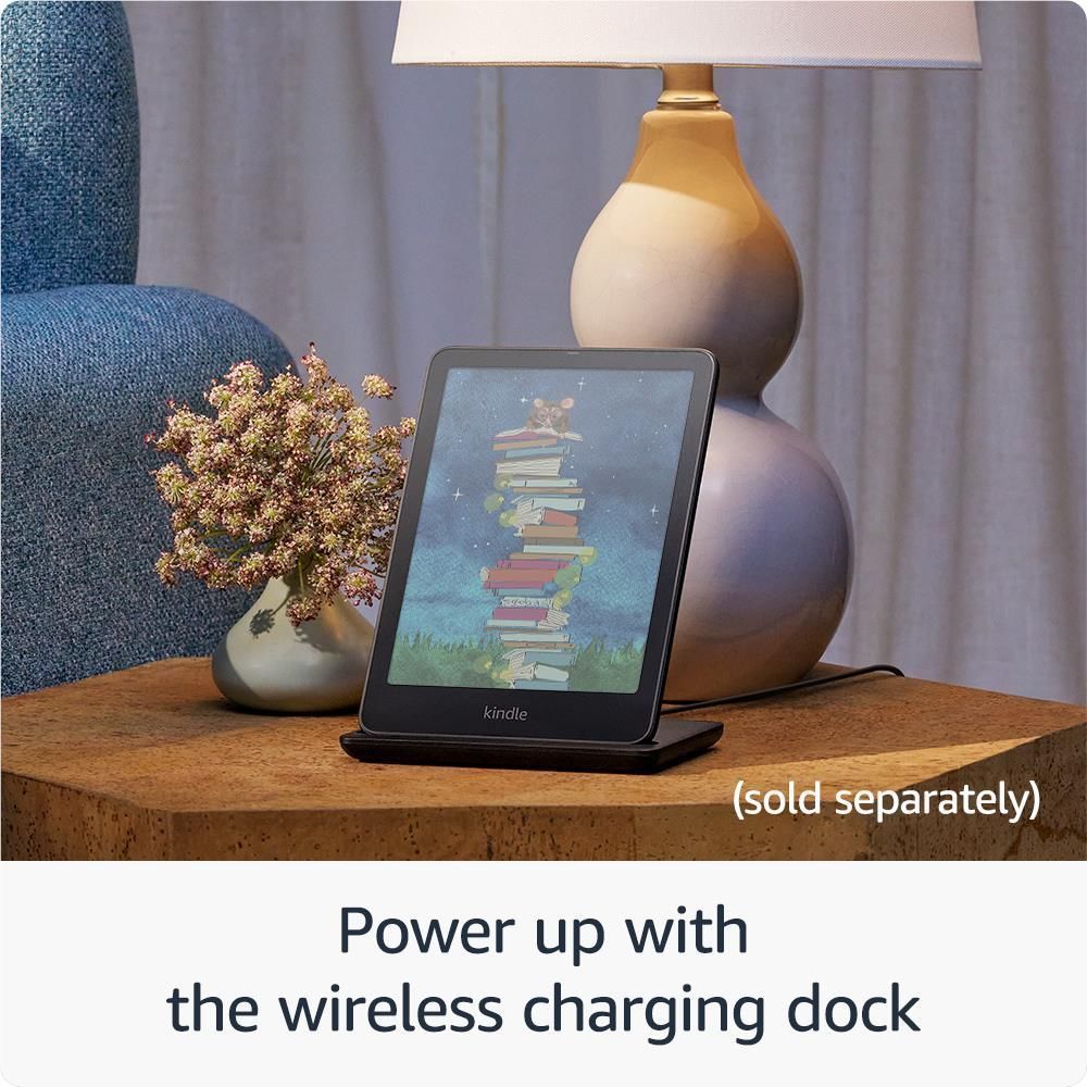Black Kindle e-reader on a stand, color display showing stacked books illustration