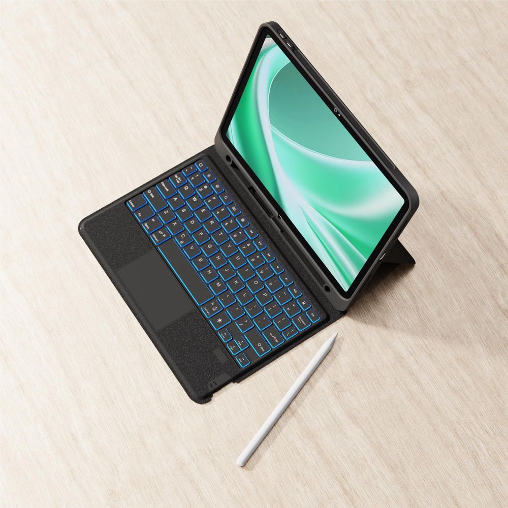 Black iPad keyboard case open with blue backlit keys on tabletop.
