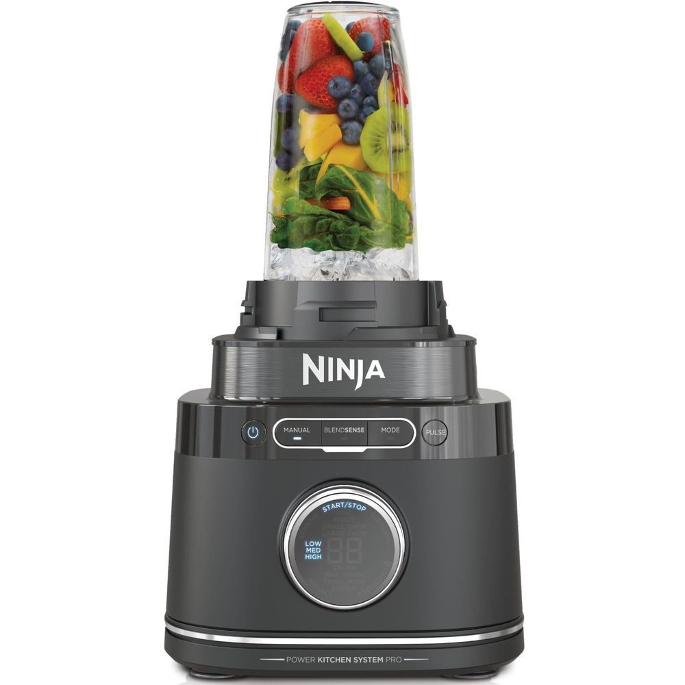 Ninja countertop blender with clear pitcher filled with mixed fruit and greens