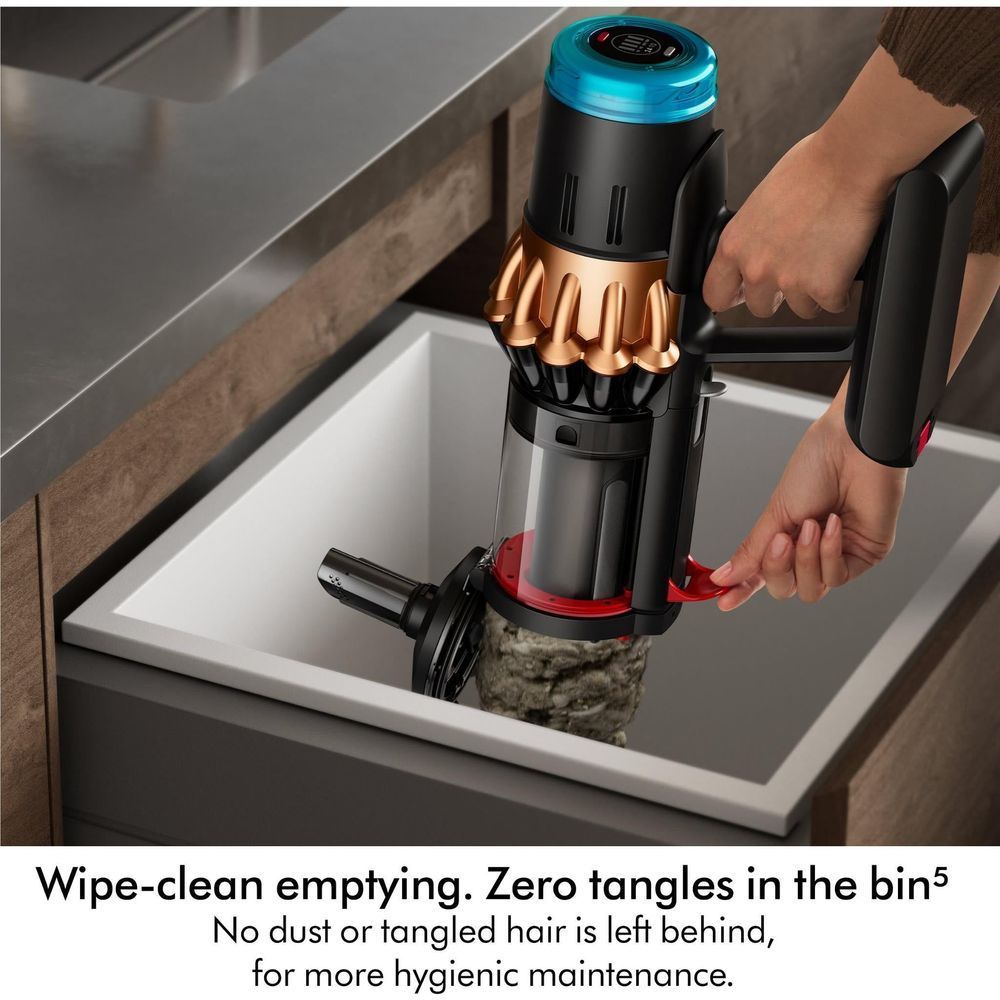Dyson dust bin and cyclone unit being emptied, black and bronze with blue top