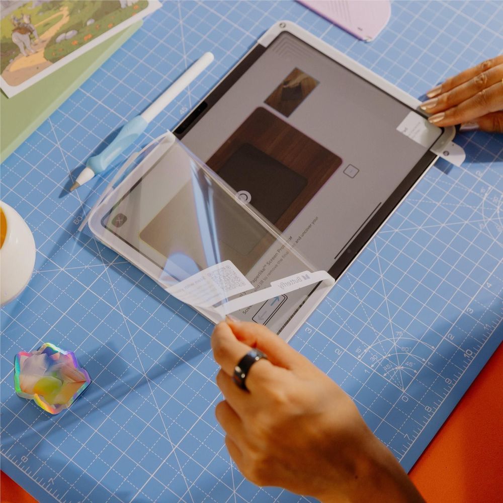 iPad Pro screen protector film laid over the display during installation