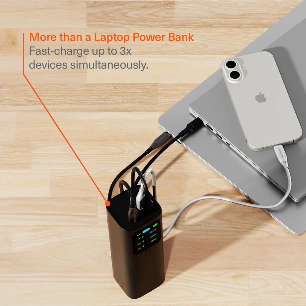 Black power bank connected to a laptop with charging cables