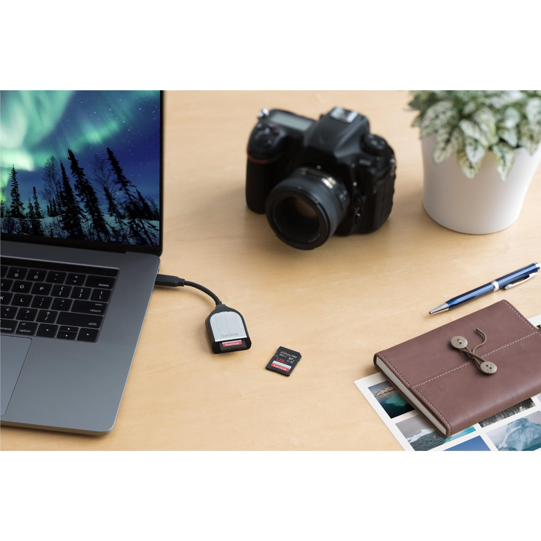 SanDisk USB-C SD card reader with USB-C cable and nearby SD card