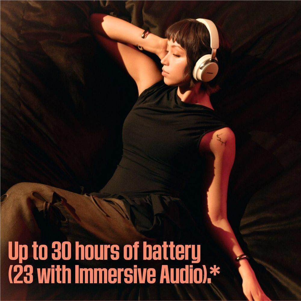 White Bose over-ear headphones worn, headband and ear cups visible