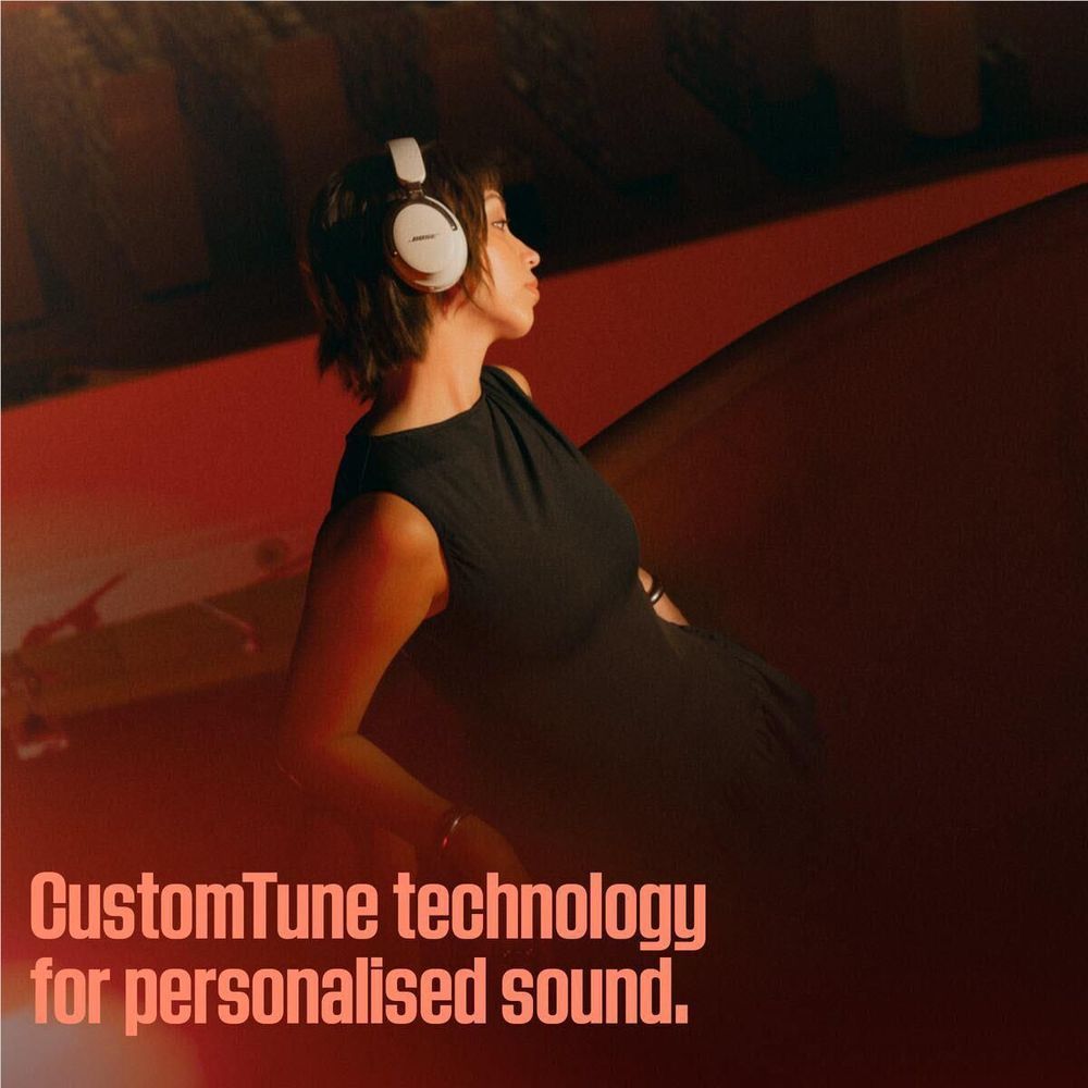 White Bose over-ear headphones worn, side ear cup and controls visible