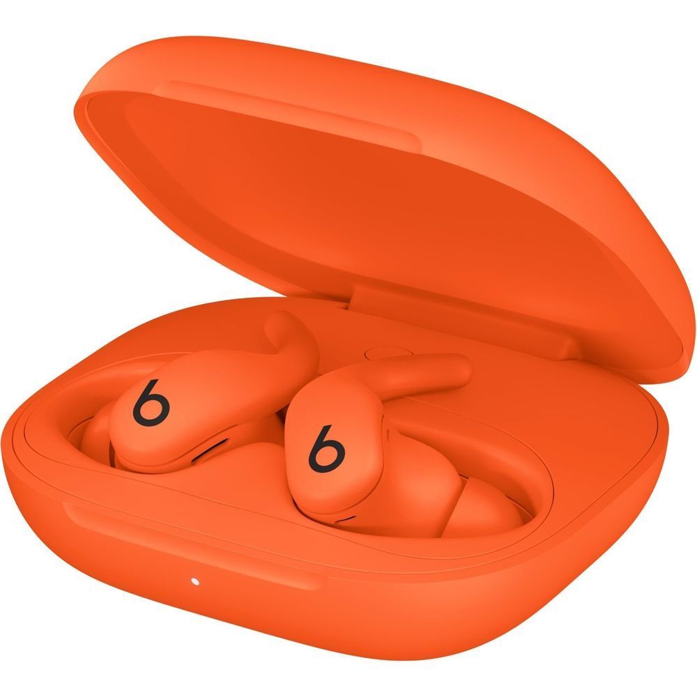 Beats Spark orange wireless earbuds seated in open charging case