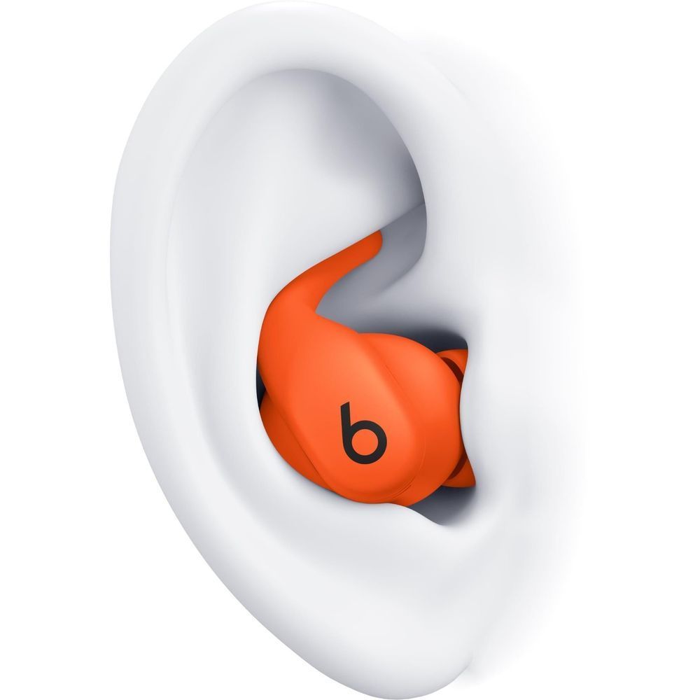 Beats Spark orange earbud worn in ear, silicone eartip visible