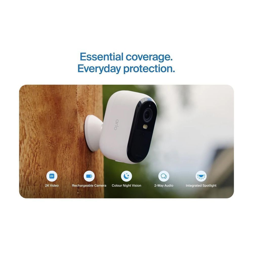 Outdoor security camera on a wall, white body with black lens module