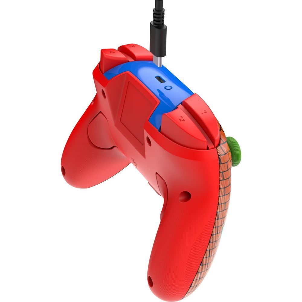 Side view of a red wireless game controller with blue grip accents, triggers, and cable port