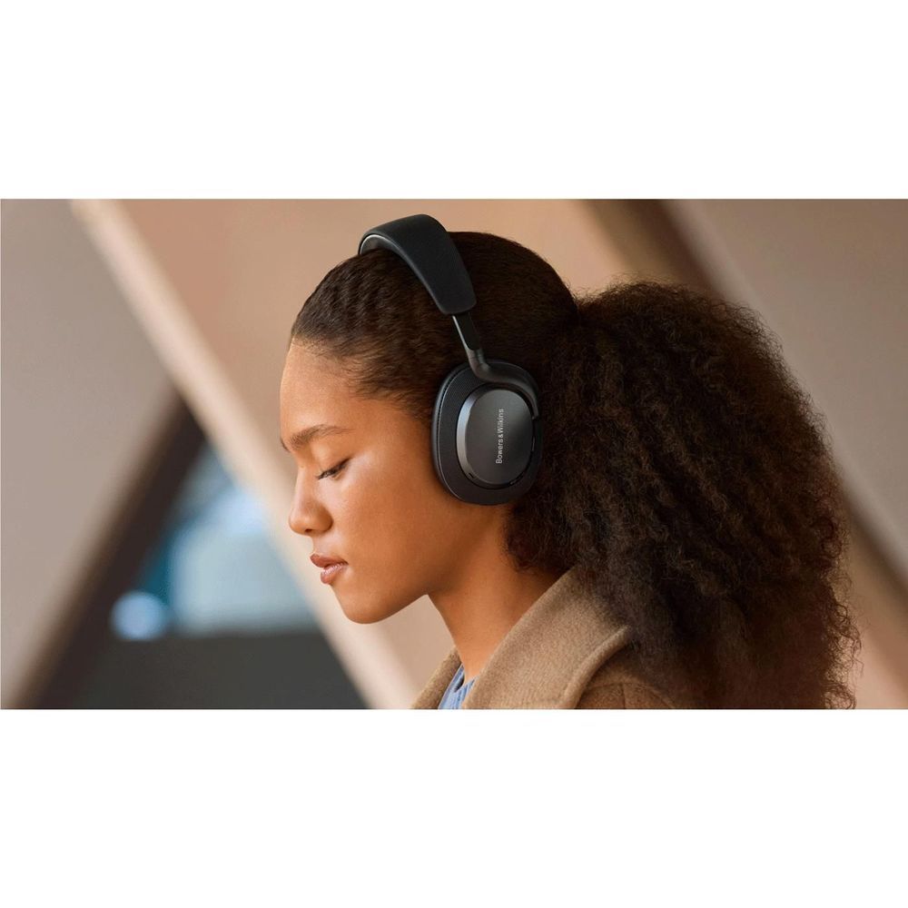 Over-ear headphones worn by a person with anthracite black cushioned earcups