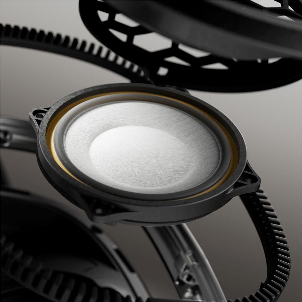 Over-ear headphone earcup close-up with exposed driver and mesh grille