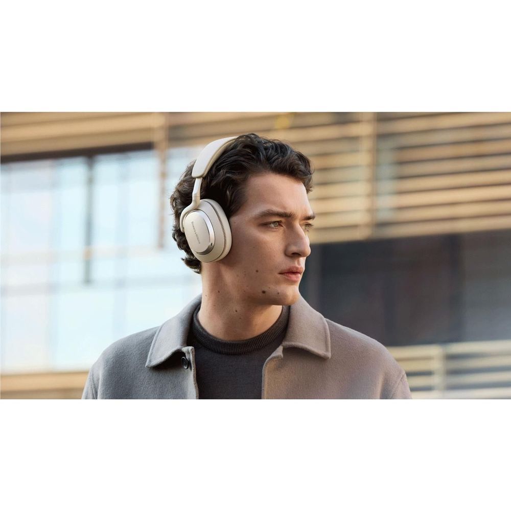 Canvas white over-ear headphones worn on model, side profile with cushioned ear cups.