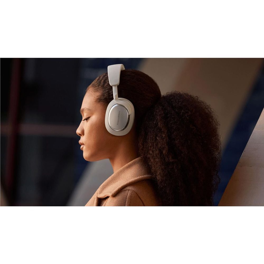 Canvas white over-ear headphones worn on model, headband and ear cup details visible.