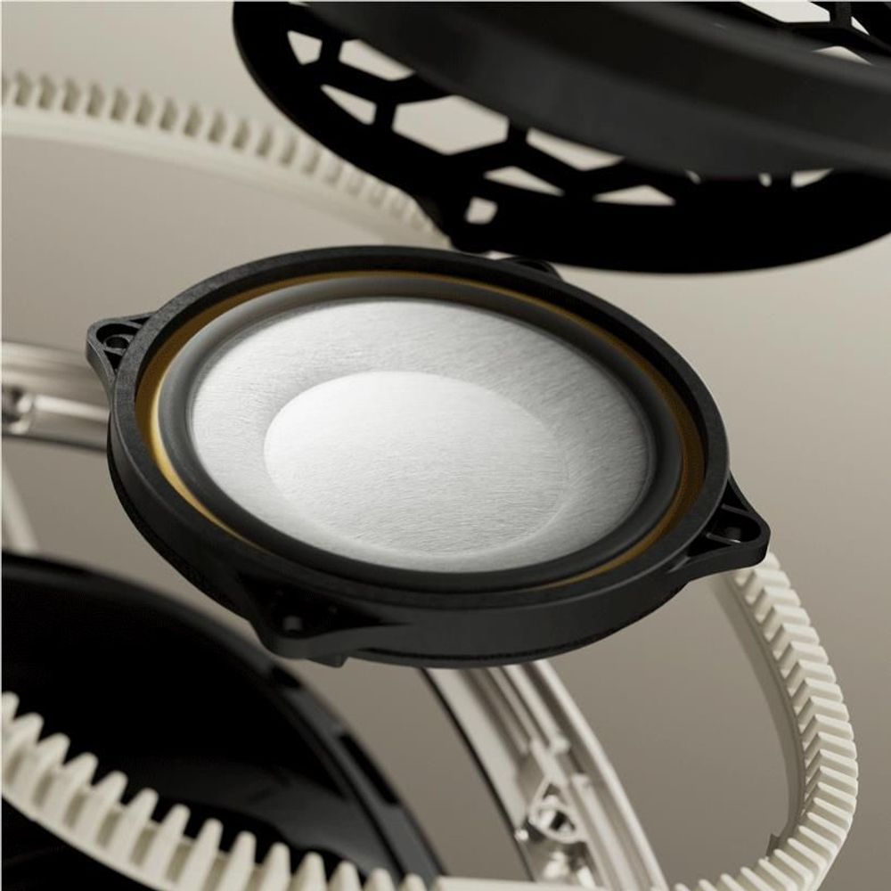 Close-up of canvas white ear cup showing speaker grille and black ring detailing.