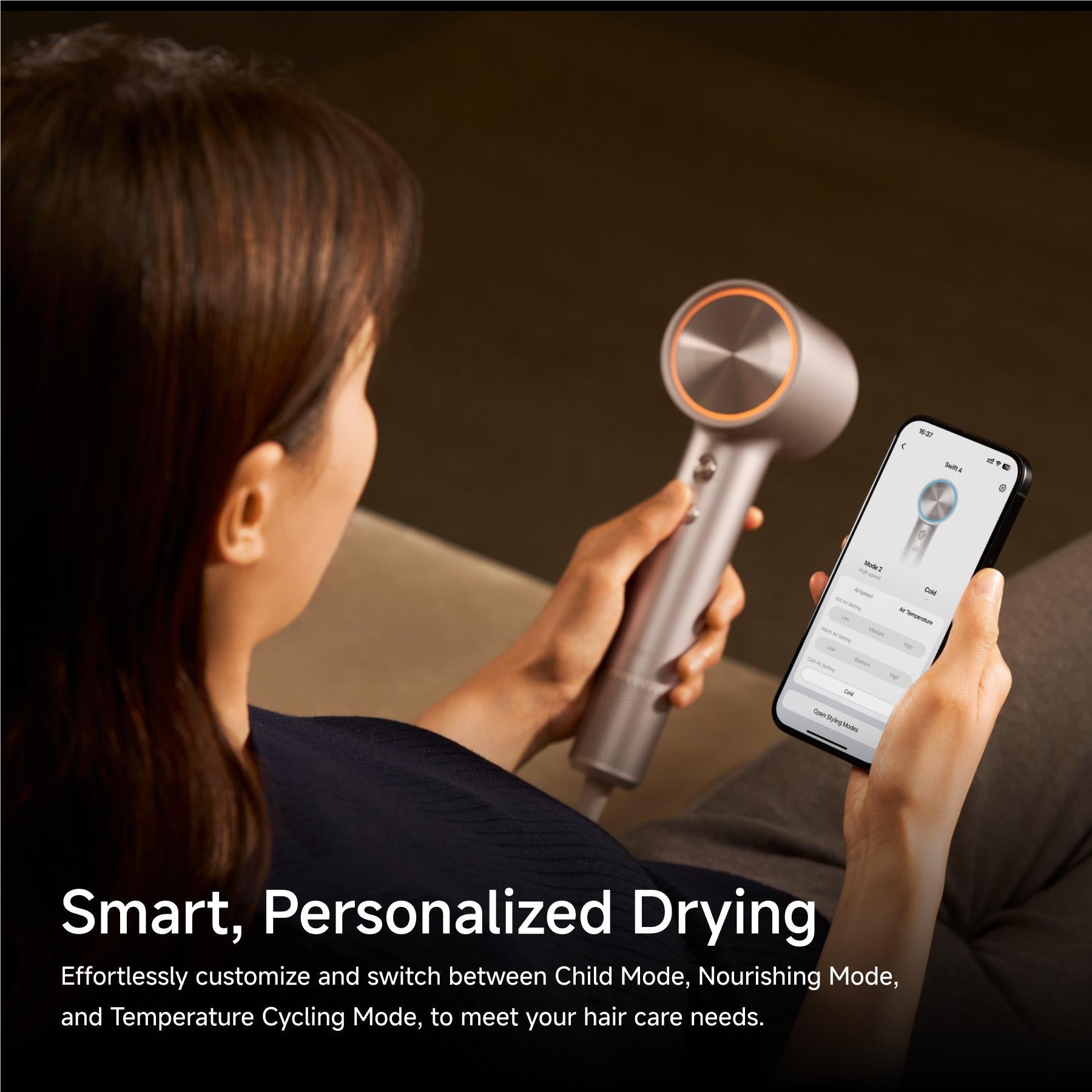 Platinum smart hair dryer held for drying with phone app control