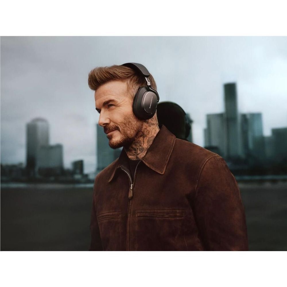 Onyx black over-ear headphones worn by a bearded man in a jacket