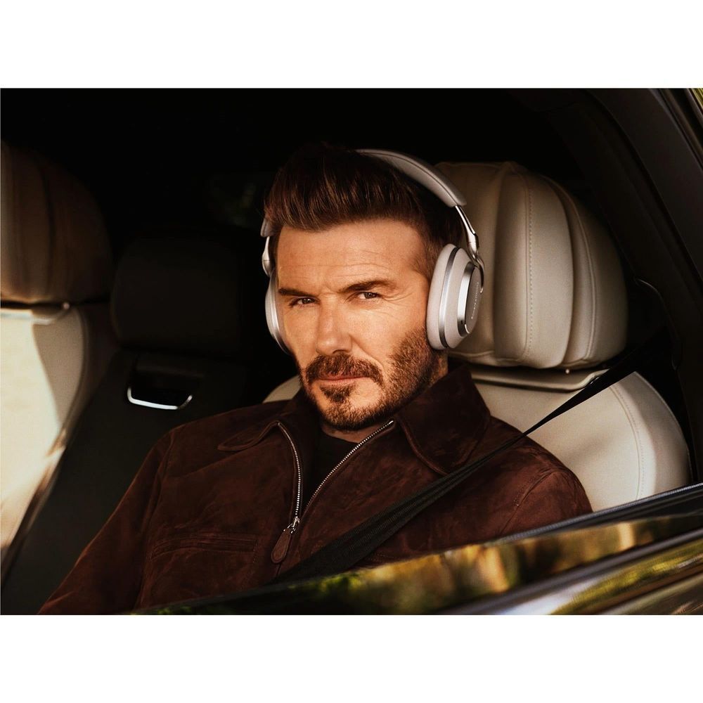 Warm Stone over-ear headphones worn by a man, side view in car