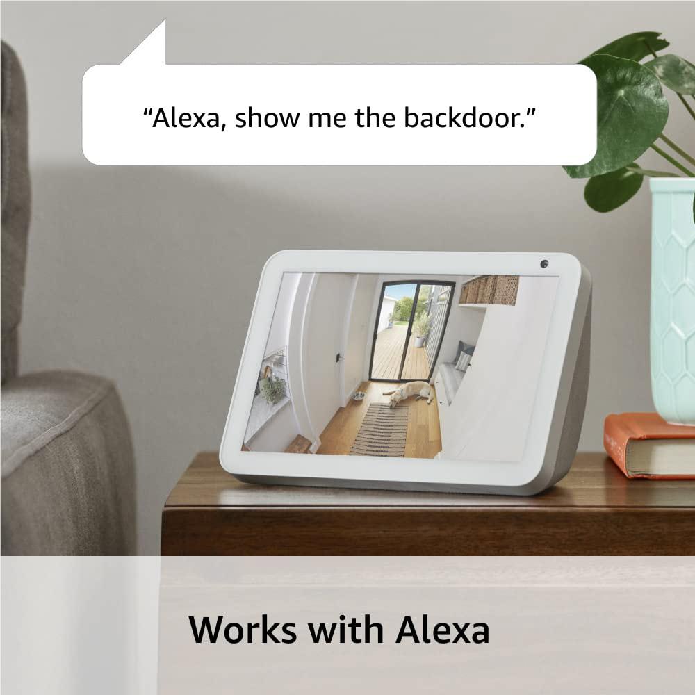 White indoor security camera on tabletop stand showing live video preview screen