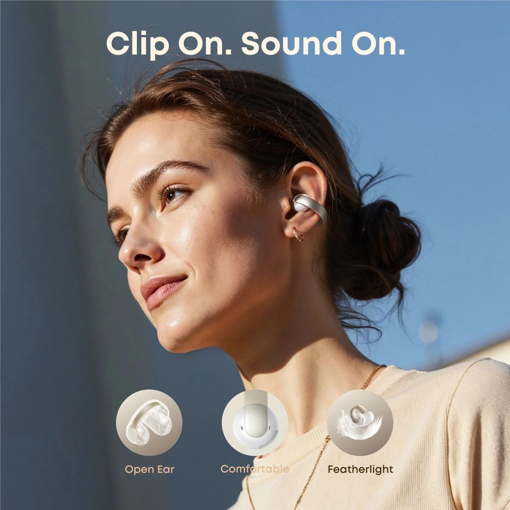 soundcore open-ear clip-on earbuds in white on ear, visible mesh speaker grille