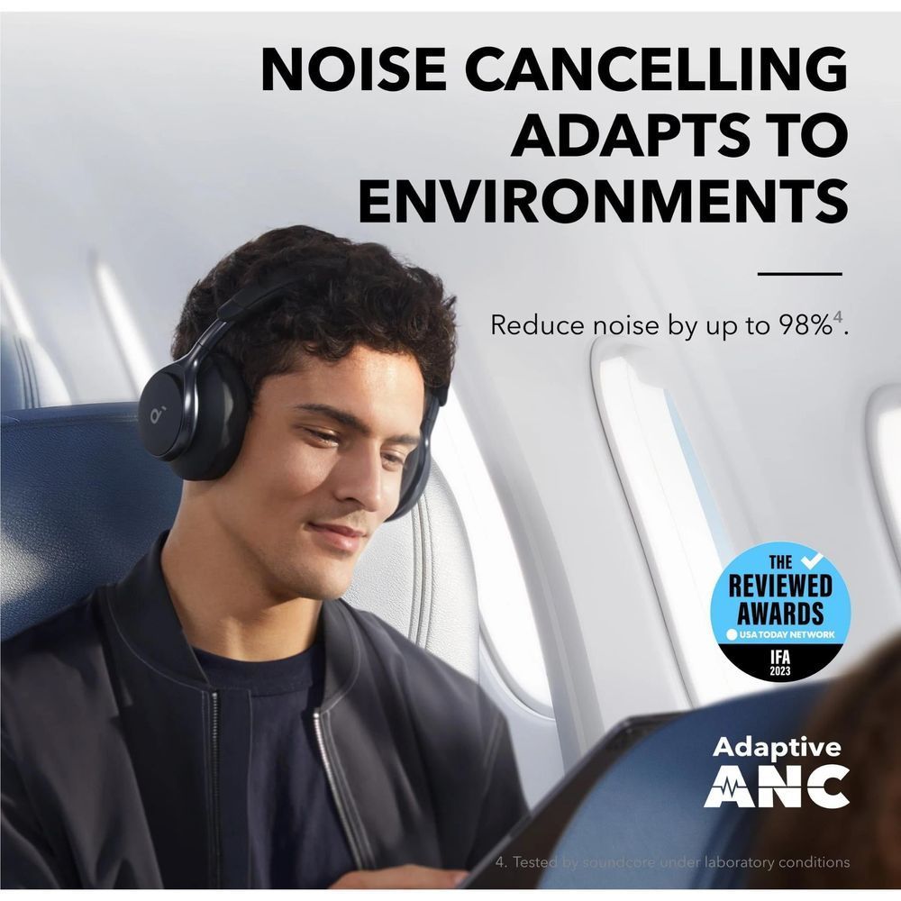 Black over-ear noise cancelling headphones being worn, padded earcups and headband visible.