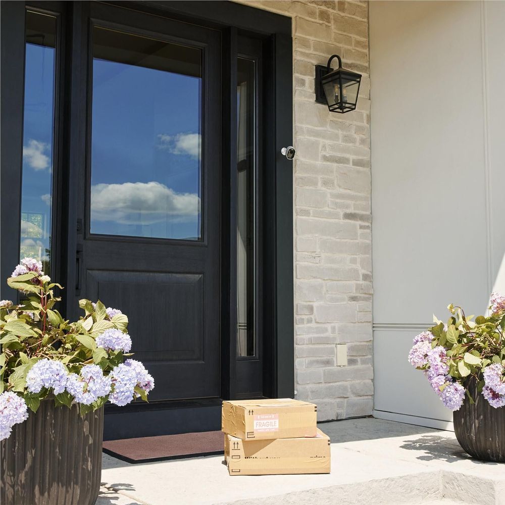 Bundle package boxes on front porch with camera and SmartHub components