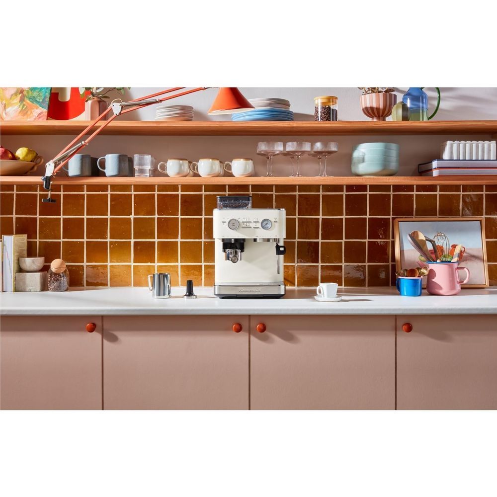 Porcelain espresso machine with grinder, cups on drip area and countertop setup