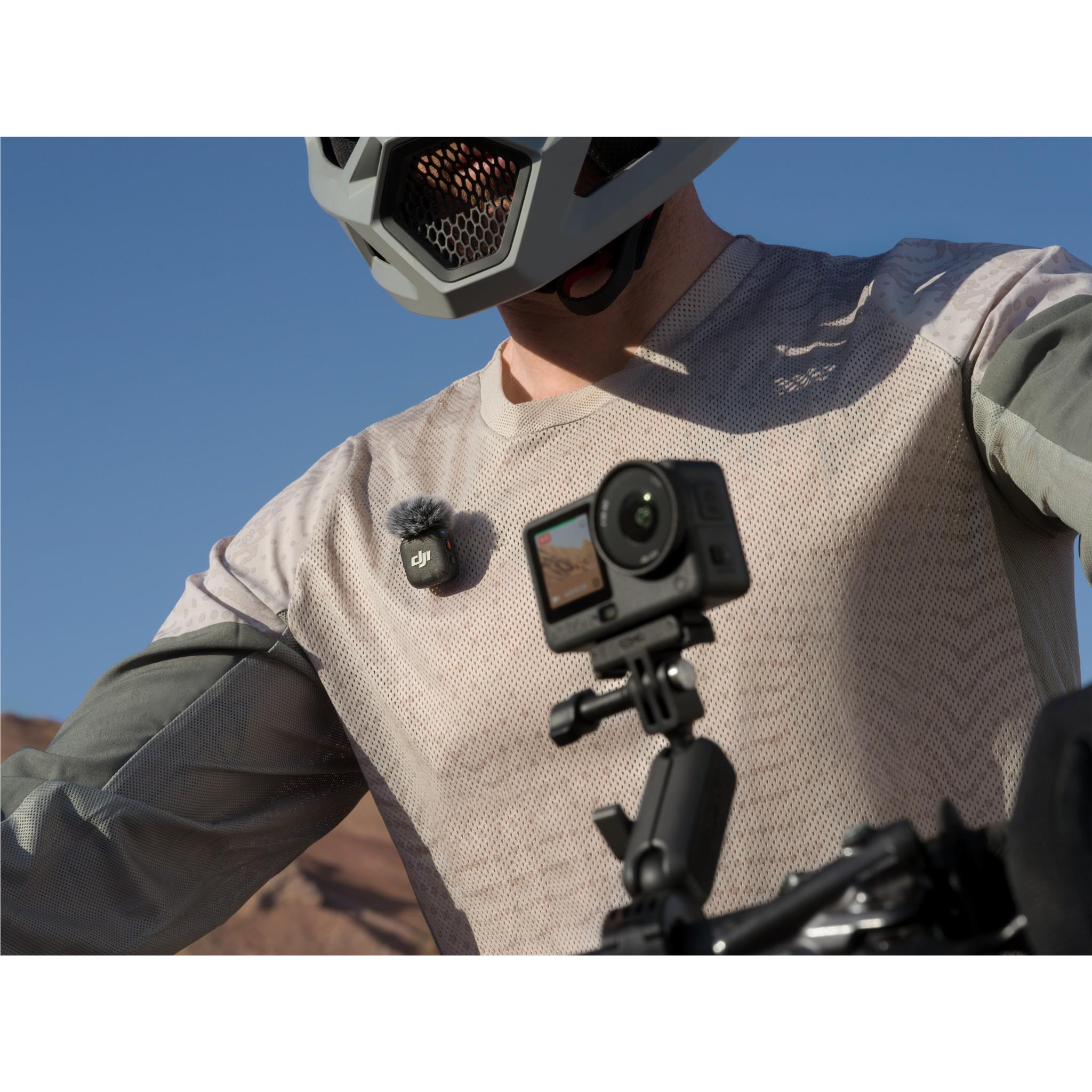Action camera with black housing, front lens and screen, mounted on a tripod grip