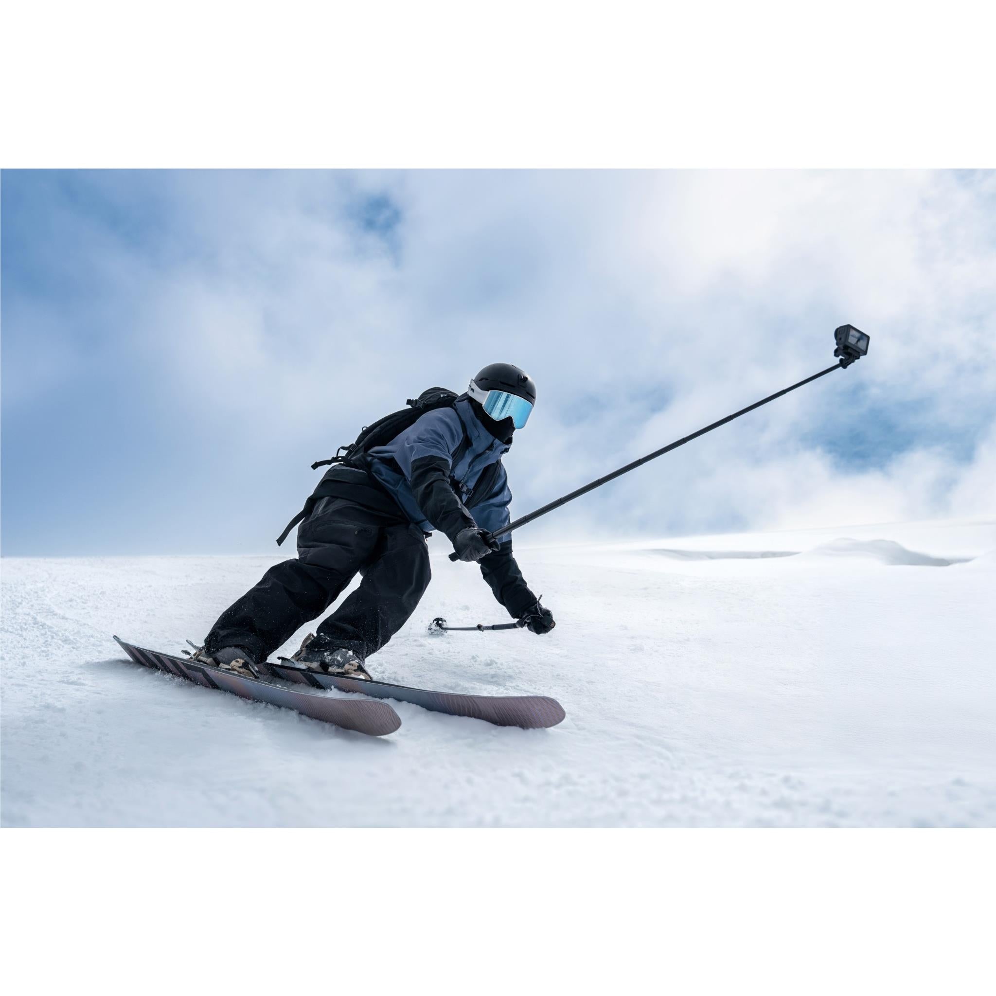 DJI action camera on a mount attached to a handheld selfie pole