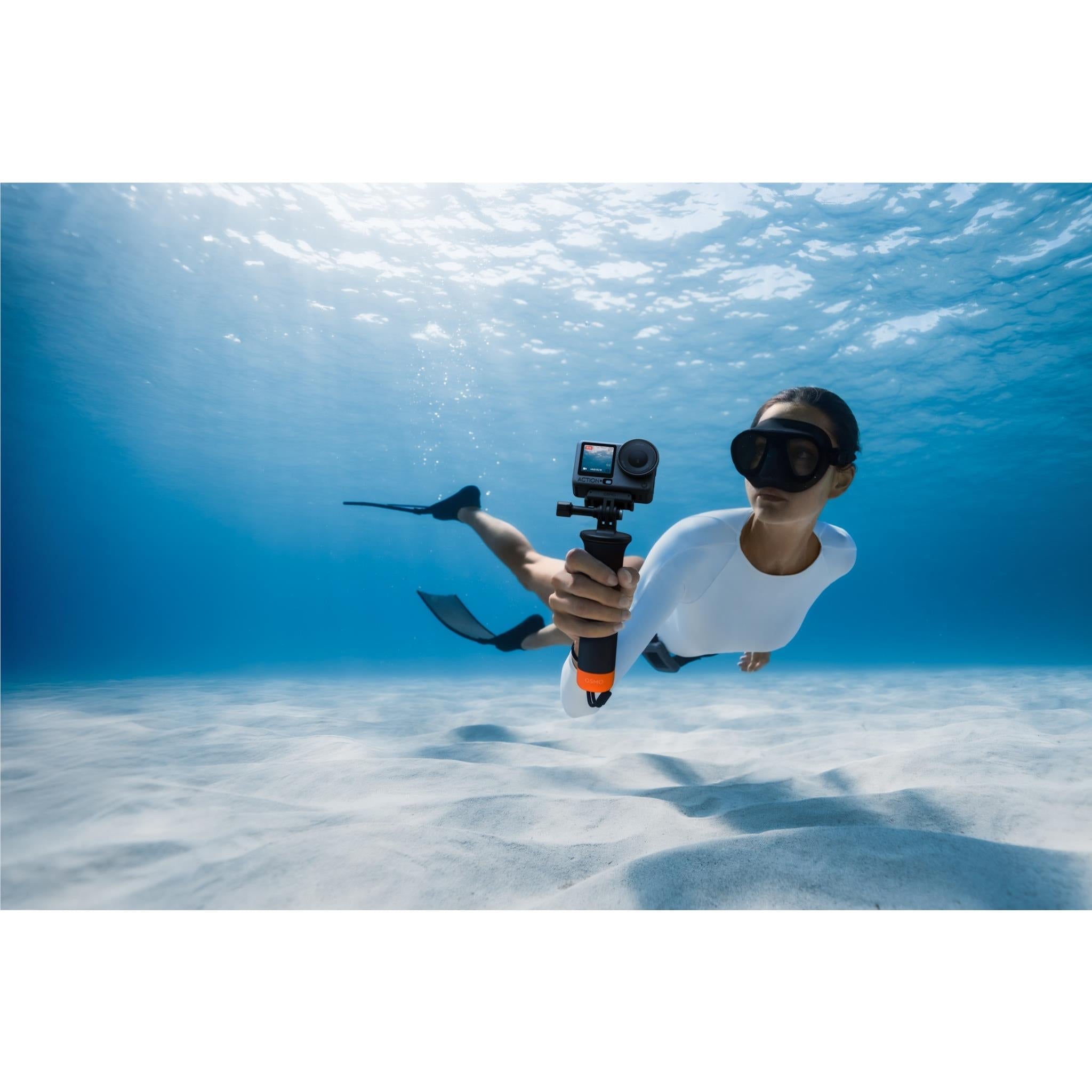 DJI action camera on a pole in water, with underwater housing visible