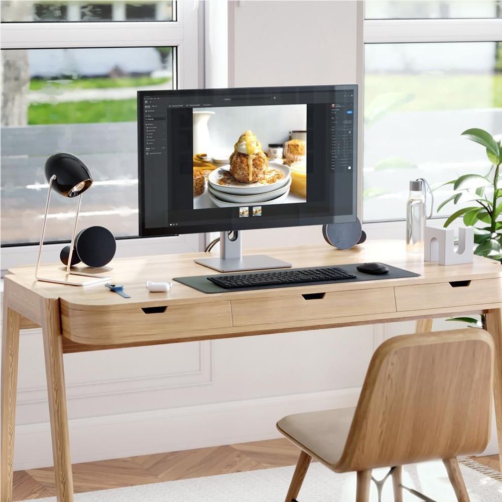 27-inch UHD monitor with silver base, showing a food photo on the display.