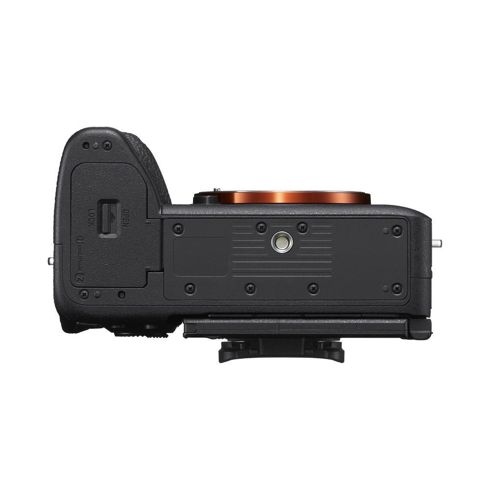 Black mirrorless camera body bottom view with tripod mount plate and battery door