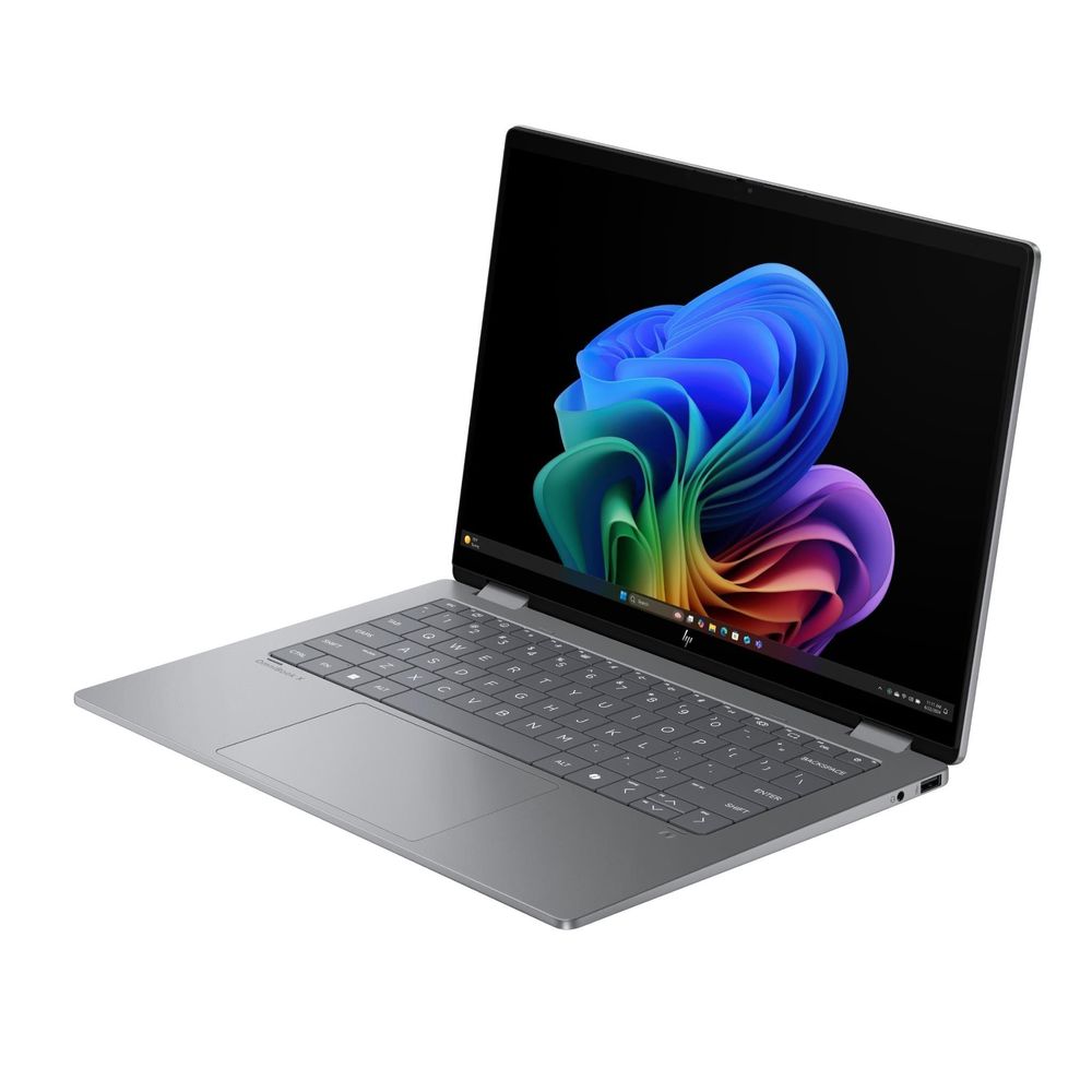 Silver 2-in-1 OLED laptop in angled view with open screen and backlit keys