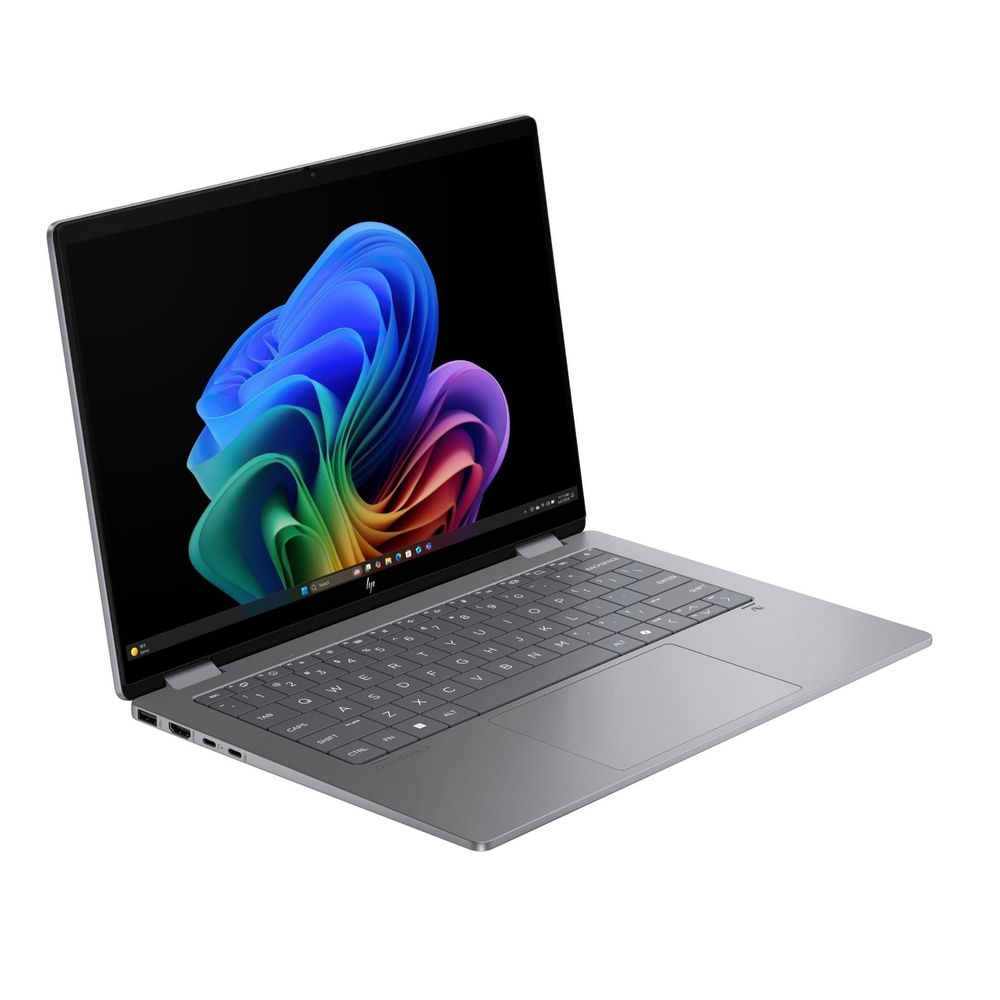 Silver 2-in-1 OLED laptop open in 3/4 view, showing keyboard and hinge design