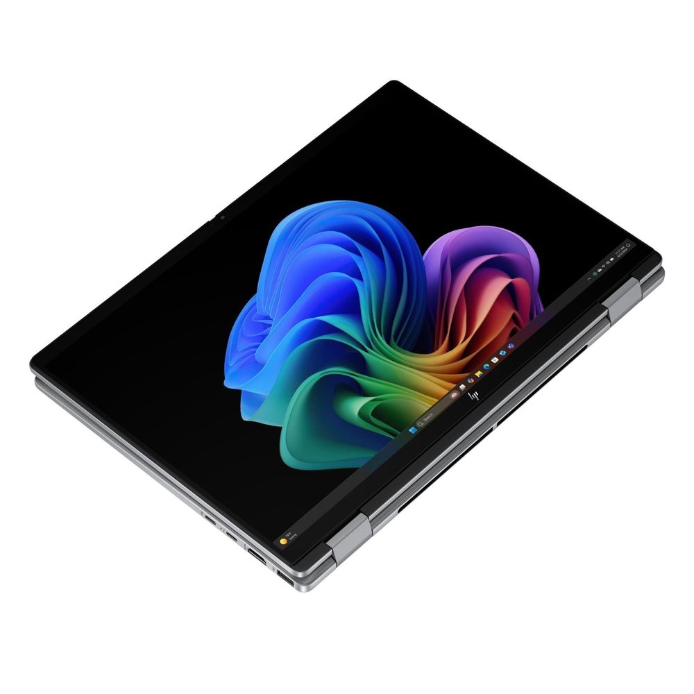 Silver 2-in-1 OLED laptop open in diagonal view, showing slim hinge and keyboard