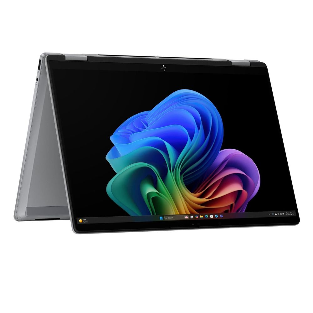 Silver 2-in-1 OLED laptop open from side angle, showing backlit keyboard