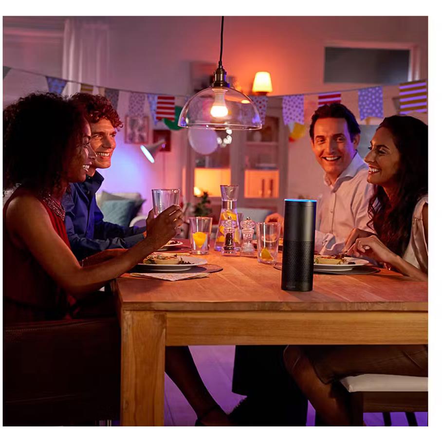 Smart bulb providing warm ambient light for a dining table gathering.