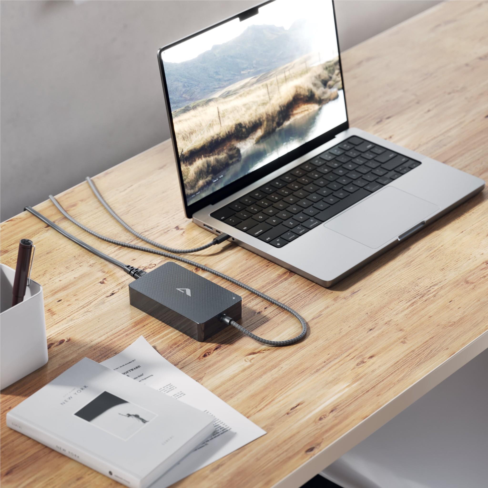 Black GaN power brick with fixed braided USB-C cable connected to laptop