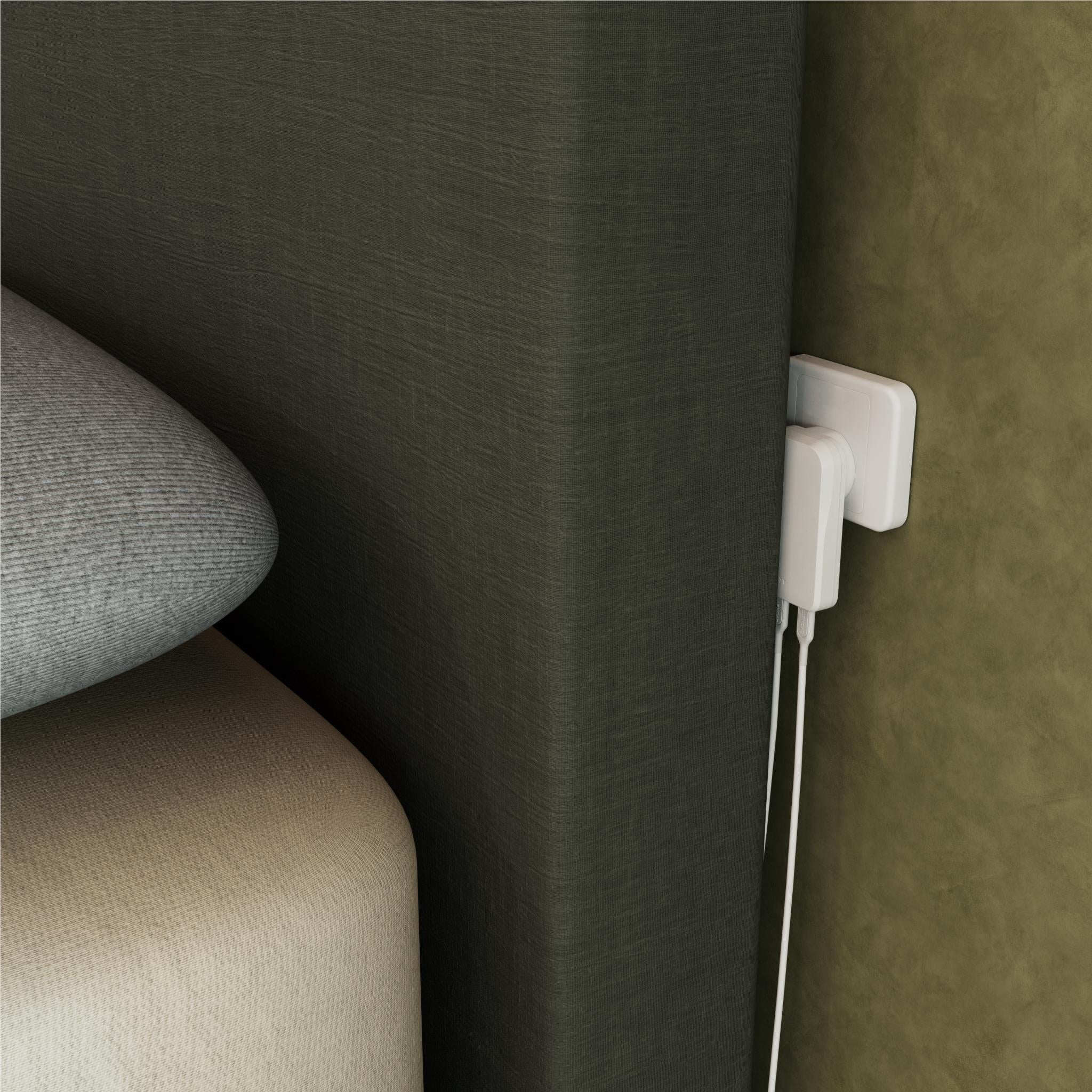 White wall charger plugged into outlet with two charging cables