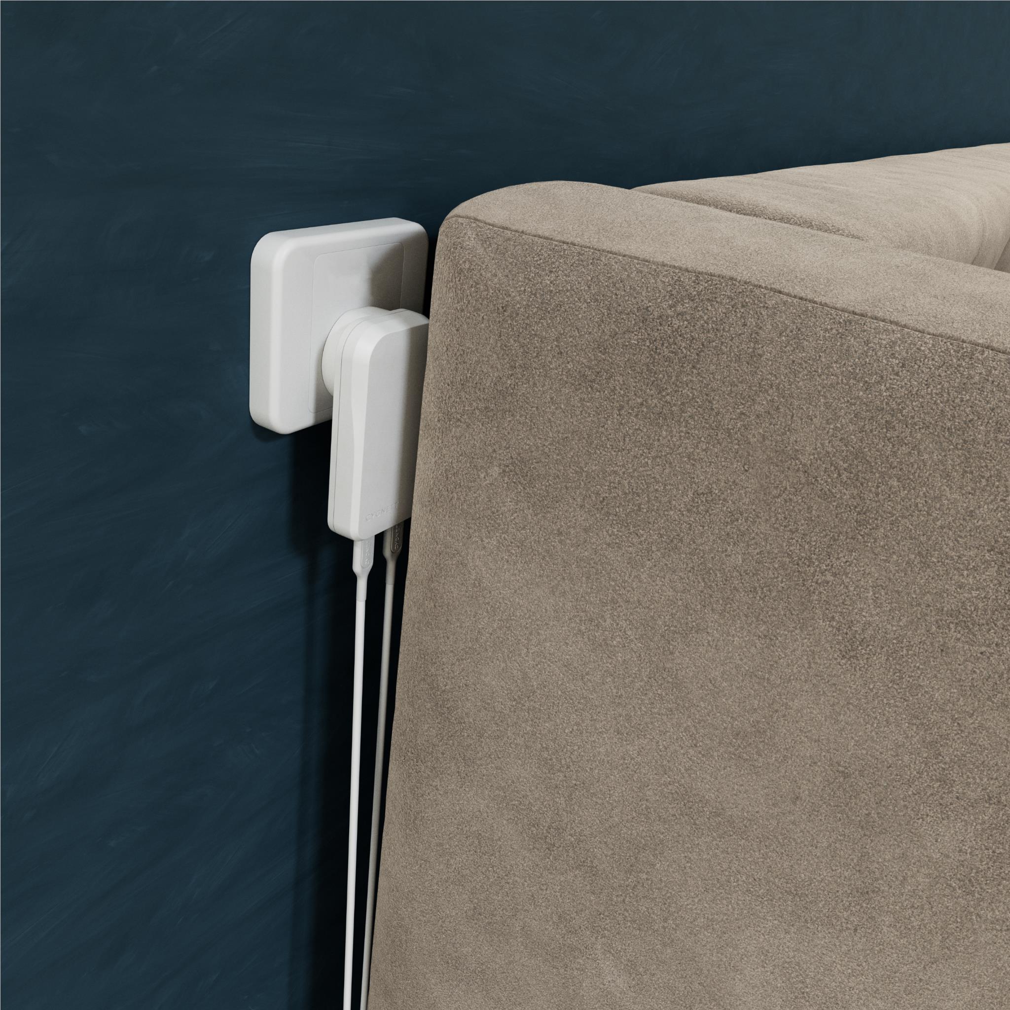 White wall charger plugged into outlet with two charging cables