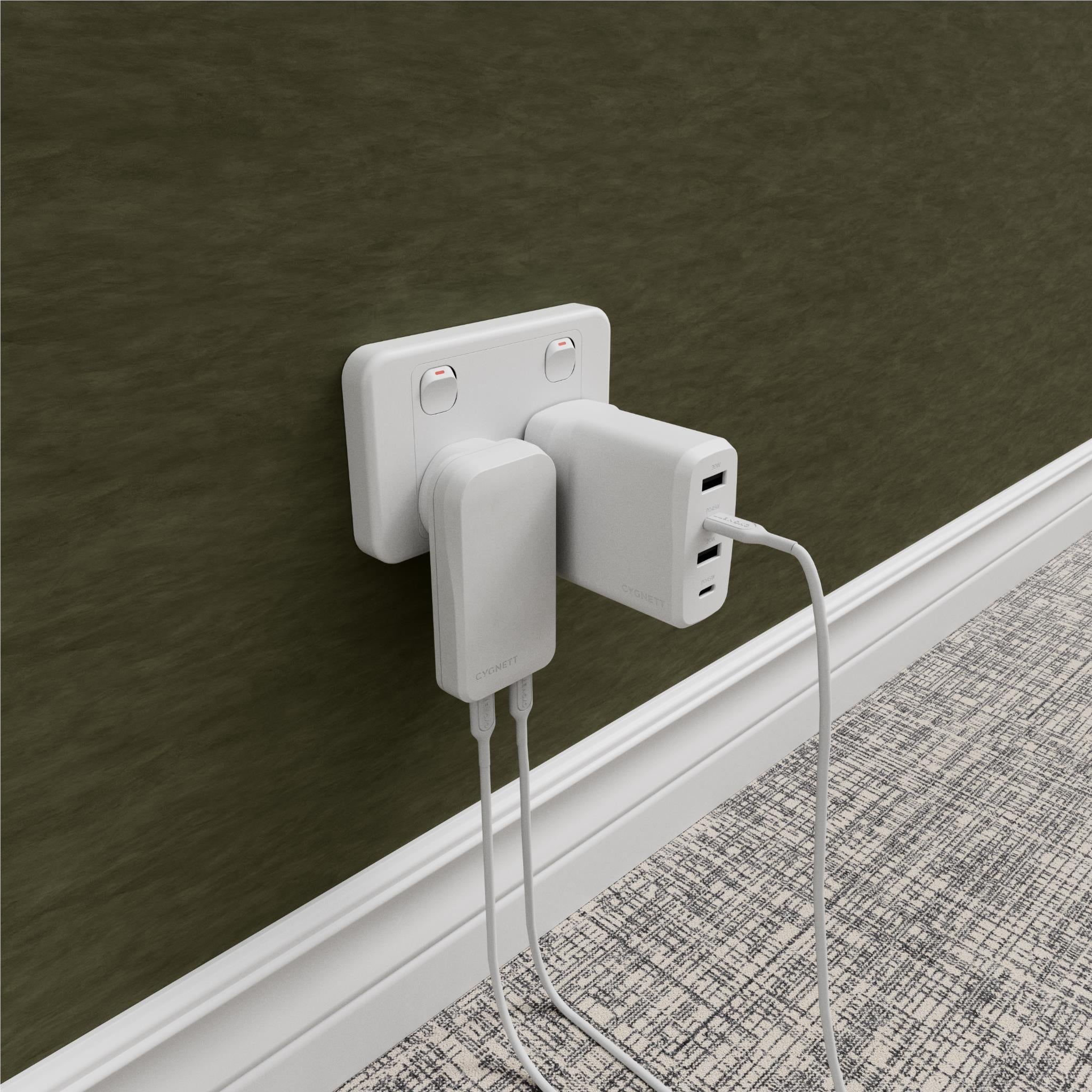 White dual USB-C wall charger plugged into wall with two cables