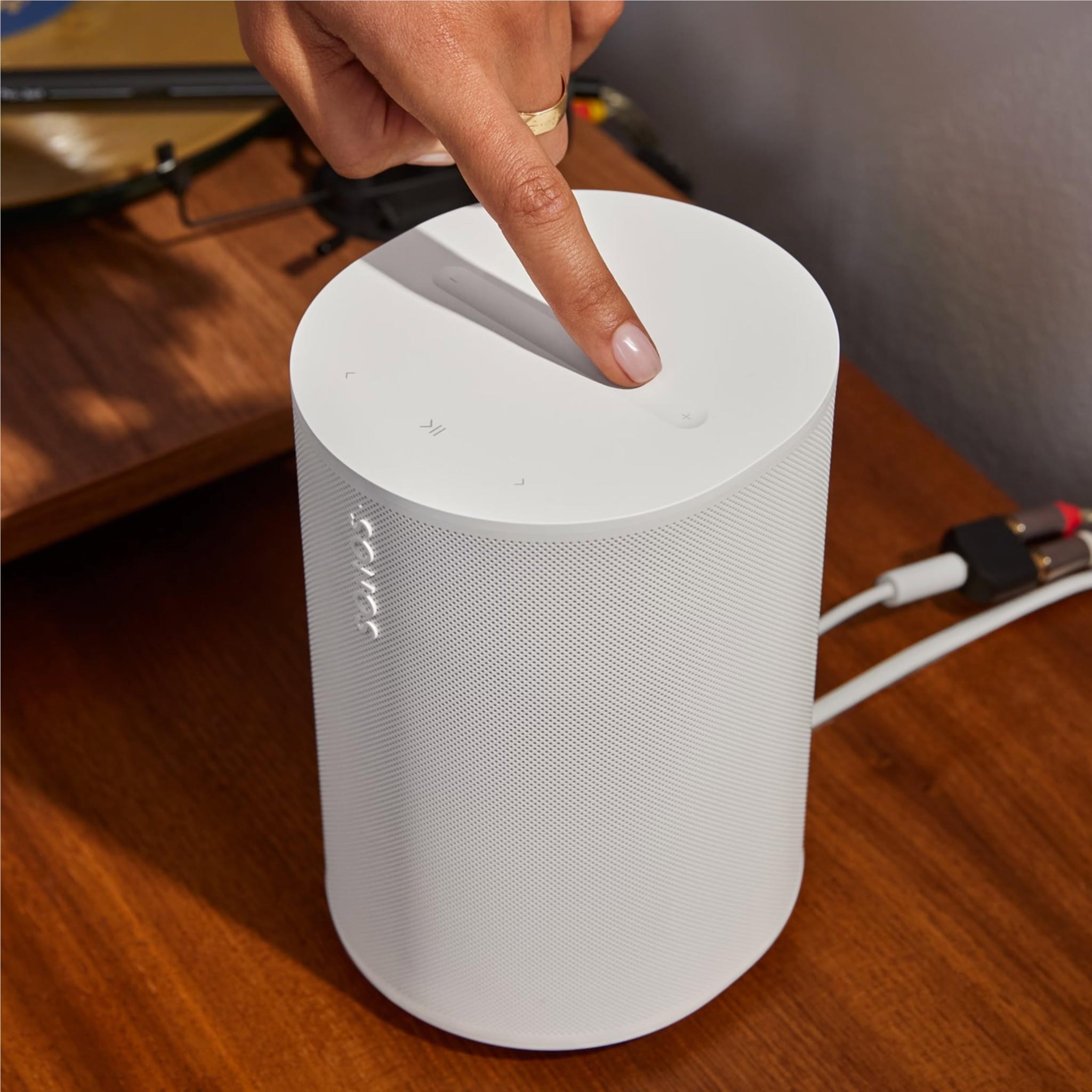 White Sonos Era 100 SL speaker top with finger touching the control panel