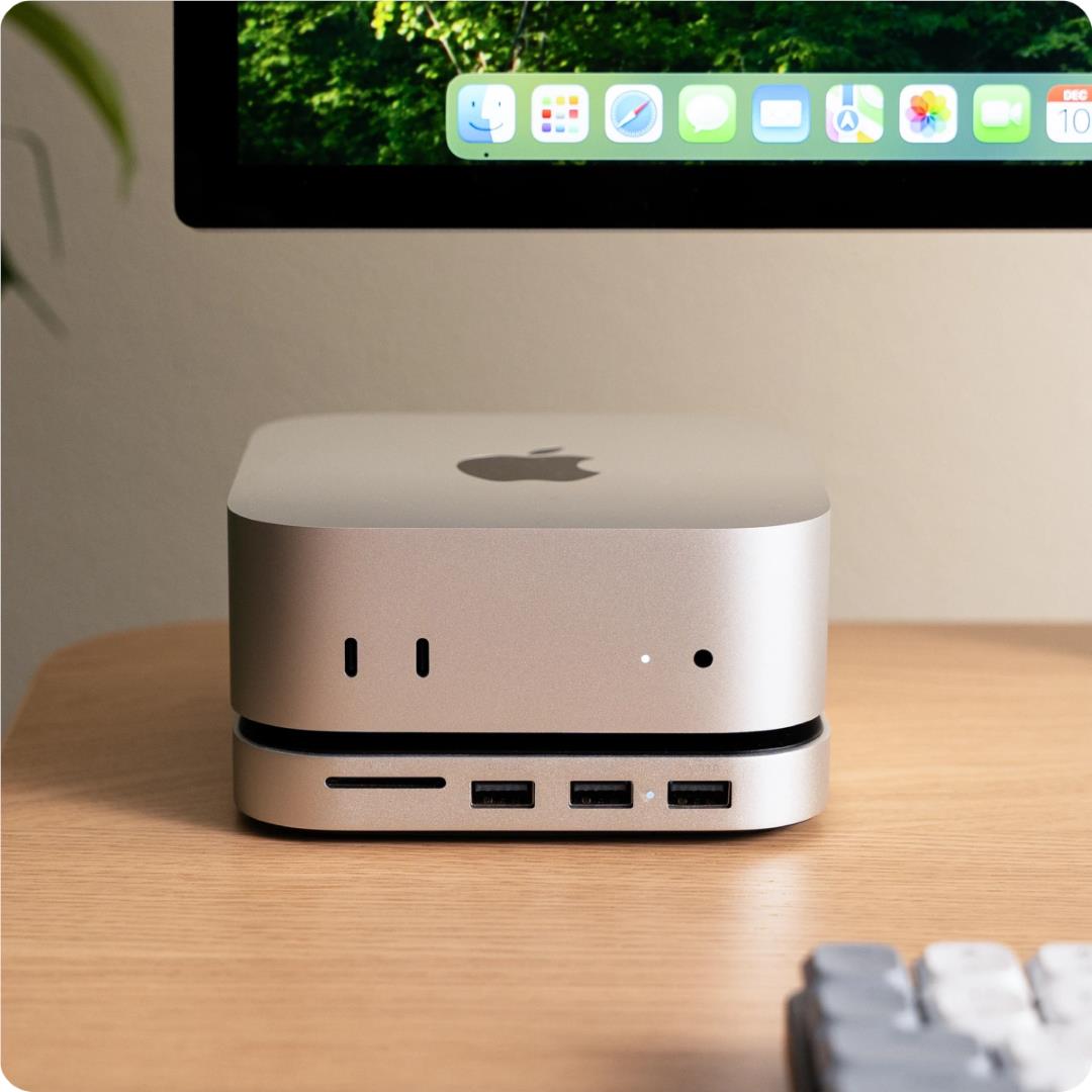 Silver Mac mini stand hub on desk with Apple logo and front port connectors