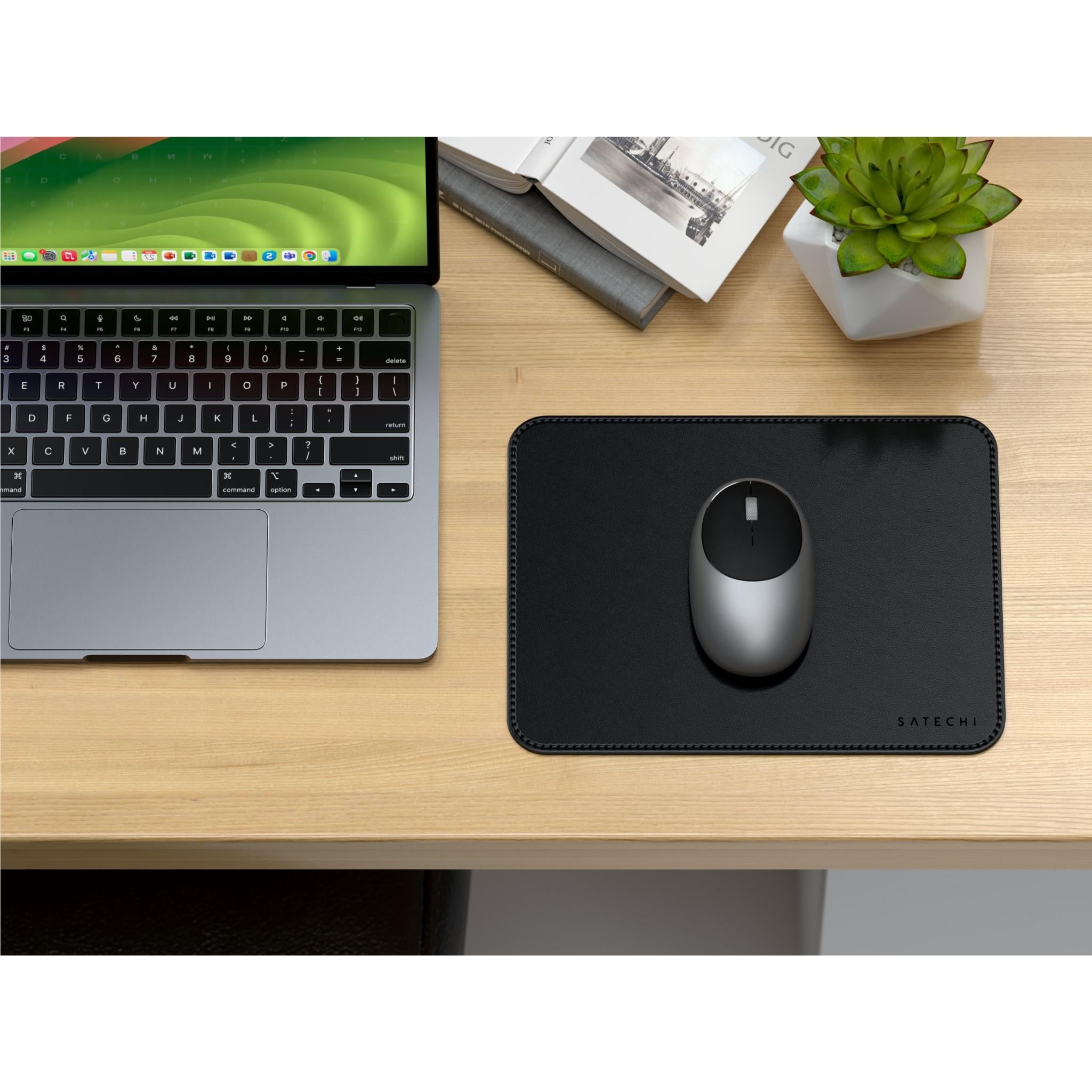 Black vegan leather mouse pad with stitched frame and optical mouse on top