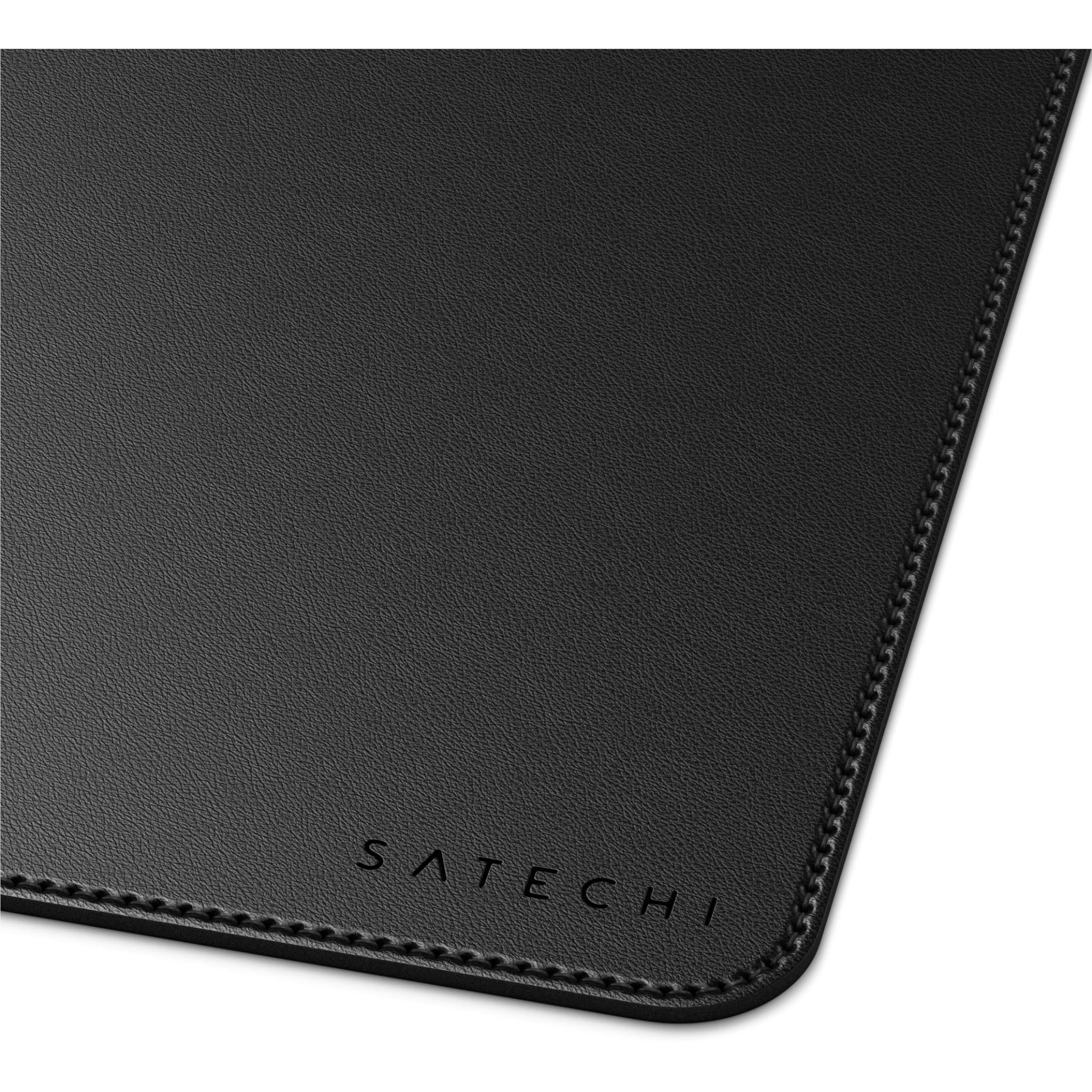 Black desk mat corner with textured surface, edge stitching, and SATECHI logo