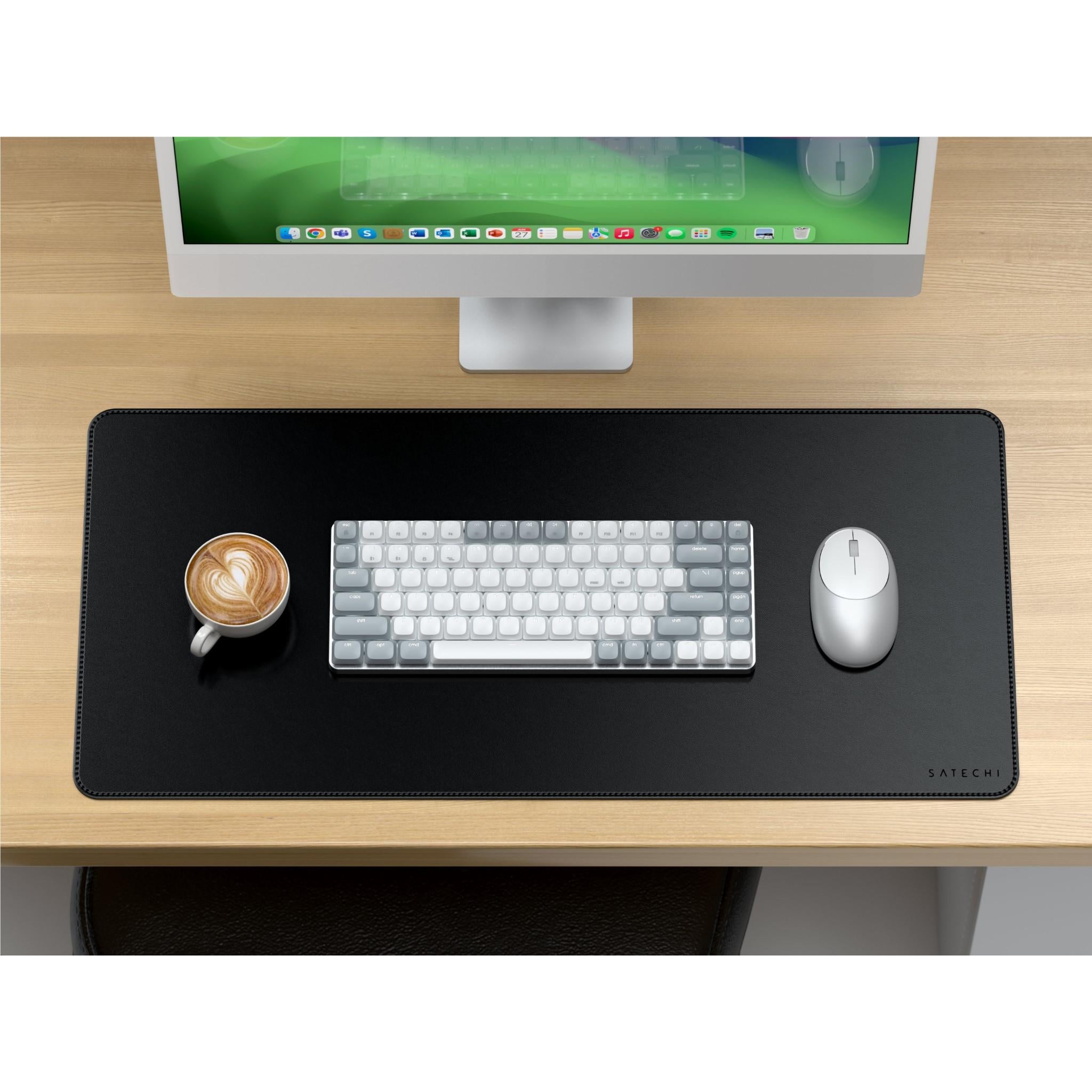 Black desk mat on a desk with keyboard and mouse placed on top