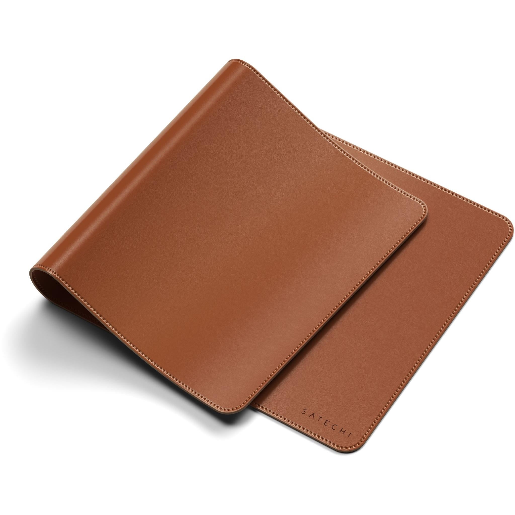 Brown desk mat shown at an angle with rounded corners and stitched edge.