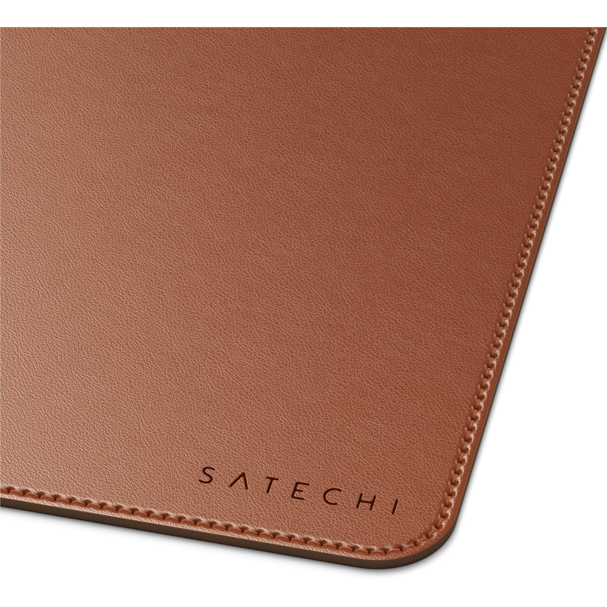 Brown desk mat corner close-up with textured finish and stitched border.