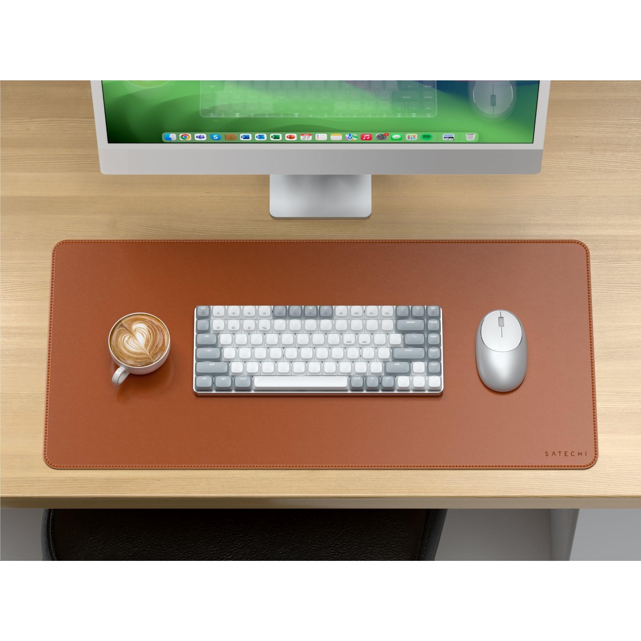 Brown desk mat on a work setup with stitched border and SATECHI logo.